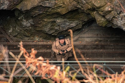 People wear black brown backpack on the rock climbing
